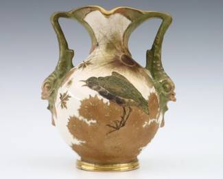 A late 19th century Amphora Art Pottery vase by Riessner, Stellmacher & Kessel. Molded body with Dolphin handles and multi-color bird and floral decoration with Gilded detail. Printed "RStK / Turn Teplitz, Bohemia" and impressed "Amphora / Austria" with Crown marks. Hairline at rim, minor surface wear. 7 1/4" high. ESTIMATE $100-150