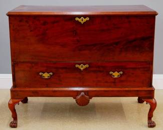 An 18th century Irish Chippendale Period blanket chest on stand. Figured Mahogany construction features a hinged lid over a single drawer with original Brass handles, a shell carving at the center of the apron, and cabriole legs ending on paw feet. Older refinishing with wear and minor damage, some staining and shrinkage cracks to lid. 51 x 26 1/2 x 41" high overall. ESTIMATE $600-800