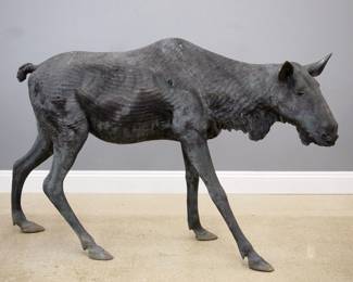A late 20th century Bronze garden sculpture of a Moose. Depicts the animal standing. Outdoor patina with wear, crack in one rear leg. 22 x 73 x 51" high overall. ESTIMATE $800-1,200