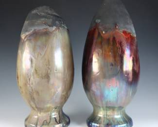 A pair of early 20th century Pewabic Pottery hanging vases. Amphora form with flared rims and iridescent drip glaze in shades of Oxblood, Dark Blue, Green and Gold over a matte Black ground. Unmarked, possibly experimental pieces. Slight crazing. Up to 11 1/4" high. ESTIMATE $800-1,200