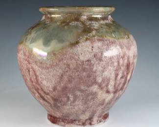 An early 20th century Pewabic Pottery vase. Bulbous form with iridescent glaze in shades of Mauve, Green and Gold. Impressed circular "Pewabic Detroit" mark, retains the original medallion "Pewabic Detroit" paper label c. 1915-1930. Crazing, firing cracks at foot from production. 6" high. ESTIMATE $800-1,200