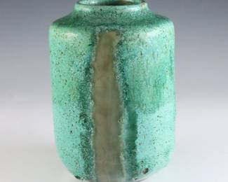 An early to mid 20th century Pewabic Pottery vase. Cylindrical form with high shoulder and drip lava glaze in shades of Green and iridescent Gold. Impressed circular "Pewabic Detroit" mark. Crazing, two burst air bubbles near foot from production. 5" high. ESTIMATE $400-600