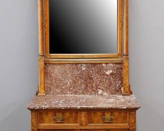 A late 19th century American Victorion Period Eastlake commode. Walnut construction with Burl panels and carved detail features a tall back with shaped crest over a beveled mirror and marble backsplash on a matching marble top base with two short dovetailed drawers over a paneled door beside two additional short drawers. Older refinishing with some wear, fading. 32 x 20 x 82 3/4" high overall. ESTIMATE $600-800