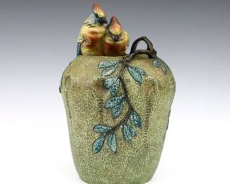 A late 19th century Amphora Art Pottery vase. Molded body with applied songbirds and branches at the rim with multi-color decoration. Printed "Amphora / Made in Czecho-Slovakia" with impressed and painted marks. Minor wear. 10 1/4" high. ESTIMATE $200-300