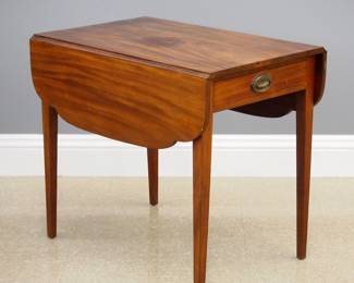 A late 18th/early 19th century American Federal Period Pembroke table. Mahogany construction features a single dovetailed drawer with original brass handle, shaped drop leaves, tapered legs. Interior of drawer contains pencil inscription "Priscilla A. Bortle's Table Care of Louisa Martin". Older refinishing with some wear, stain to the top. 21 3/4 (41 1/2 open) x 32 3/4 x 29" high overall. ESTIMATE $300-500