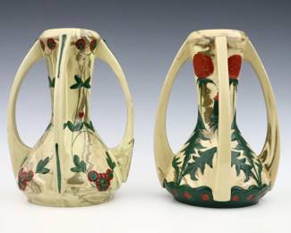 Two turn of the century Austrian Art Pottery vases. Molded bodies with four handles and multi-color floral decoration. One with printed "Austria" mark, impressed numerals. Minor wear. Up to 10 1/2" high. ESTIMATE $300-400