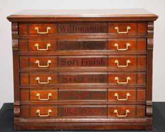 A 19th Century Willimantic Spool Cabinet. Walnut construction features six labeled drawers with brass handles flanked by pilasters at either side with an advertising panel verso featuring and Owl with spools of thread. Old refinish with some wear, some small nicks overall, no dividers. 24 1/4 x 18 x 20 1/2" high overall. ESTIMATE $600-800