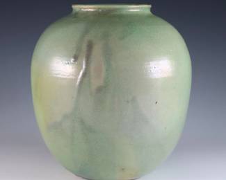 An early 20th century Pewabic Pottery vase. Ovoid form with iridescent glaze in shades of Green and Gold. Impressed circular "Pewabic Detroit" mark. Crazing, minor surface wear. 6 1/2" high. ESTIMATE $800-1,200