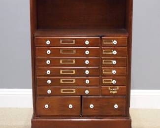 A late 19th century Danner's Patent Revolving Lawyer's Cabinet. Walnut construction features small drawers with porcelain knobs and paneled doors enclosing small shelves on blocked plinth with revolving stand on casters; Stenciled label "Danner's Revolving Book Case Pat'd (illegible) Feb 20 Dec. 11 1877 John Danner Canton, Ohio". Refinished with minor wear, lacking some shelves. 26 1/2 x 26 1/2 x 41" high overall. ESTIMATE $800-1,200