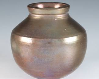 An early to mid 20th century Pewabic Pottery vase. Bulbous form with iridescent glaze in shades of Oxblood, Copper and Gold. Impressed circular "Pewabic Detroit" mark. Slight surface wear, area with a few tiny flakes at rim. 4 1/2" diameter x 4 1/4" high overall. ESTIMATE $400-600