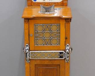 An early 20th century Mutoscope Autostereopticon drop card coin-op arcade machine. 10 cent viewer depicts the "San Francisco Earthquake" in a series of moving cards. In a molded Oak cabinet with marque top and applied Nickel plated castings. Restored working condition, repairs and replacements. 20 x 17 x 67 1/2" high overall. ESTIMATE $800-1200