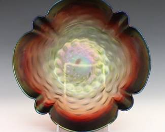 A turn of the century Rindskopf Art Glass bowl. Crimped Rubina Verde glass body and Iridescent finish. Unmarked. Minor surface wear and fleabites. 10 x 4" high overall. ESTIMATE $100-200