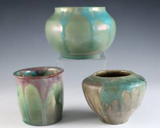 Three early 20th century small Pewabic Pottery vases. Bulbous and cylindrical forms with iridescent drip glazes in shades of Green, Blue and Oxblood. Two with impressed circular "Pewabic PP Detroit" marks used c. 1930, the other with impressed circular "Pewabic Detroit" mark. Some crazing, particularly to smallest which also has surface wear and a burst air bubbles from production. Up to 4" diameter x 3" high overall. ESTIMATE $1,000-2,000