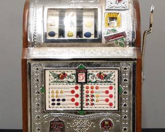 An early 20th century Mills "Spearmint Operators Bell" model 5 cent slot machine. One armed bandit style machine with Nickel plated iron panels and Oak ends with stenciled detail features an upper coin slot over three wheels behind a curved glass panel above a payout card behind glass all on a molded Oak base. Restored working condition, replaced back panel. 16 x 15 x 24 3/4" high. ESTIMATE $600-800