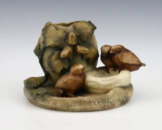 A late 19th century Amphora Art Pottery vase. Molded body with three Chicks perched under an Oak leaf with multi-color decoration and Gilded detail. Impressed "Amphora / Austria" marks. Minor wear, some crazing. 7 1/2 x 4 1/4" high overall. ESTIMATE $200-400