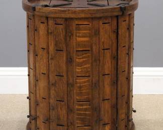 A 19th American century lace and ribbon dispenser. Oak construction features revolving cylindrical form with four doors having 20 slots each to dispense lace or ribbon. Wear overall, with two cranks lacking wood knobs. 23" diameter x 29 1/4" high overall. ESTIMATE $600-1,000