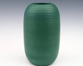 An early 20th century Michael Andersen & Son Art Pottery vase. Molded ovoid form body with ribbed texture and matte Green glaze. Applied lozenge with Danish Three Fish in a Shield and impressed marks. Minor wear, two small flakes at lower body. 9" high. ESTIMATE $200-300