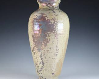 An early 20th century Pewabic Pottery vase. Baluster form with linear ribbed body and iridescent glaze in shades of Pale Green, Lilac and Gold. Retains the original medallion "Pewabic Detroit" paper label with two dots c. 1915-1930. Repair to rim and length of neck, some crazing and minor surface wear. 10 1/2" high. ESTIMATE $800-1,200
