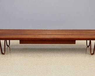 A Mid Century Modern bench by Edward Wormley for Dunbar, c. 1946. Model 4699 in Walnut with molded top and hanging drawer on bentwood legs. Retains original label and brass "Dunbar" plate. Original finish with minor wear. 84 x 19 x 12" high overall. ESTIMATE $800-1,200