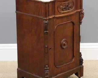 A late 19th century American Victorian Period Renaissance Revival night stand. Walnut construction with a shaped White marble top over a dovetailed drawer and single lower door, with applied carving and a scrolled base. Older refinishing with wear, some staining to the marble. 19 x 16 x 31 1/2" high overall. ESTIMATE $200-300