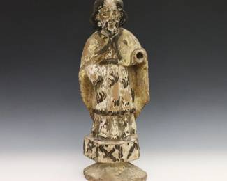 A late 18th/early 19th Century Spanish Colonial Santos. Carved wood with polychrome decoration of a male saint, possibly St. Roch, with long hair and a beard. Wear and some losses overall. 14" high. ESTIMATE $100-200