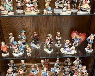 Large collection of Hummel figurines.