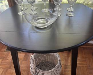 Drop-leaf table; etched crystal wine glasses.