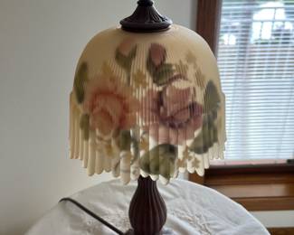 Table lapp with hand-painted floral glass, shade and ruffled edge.