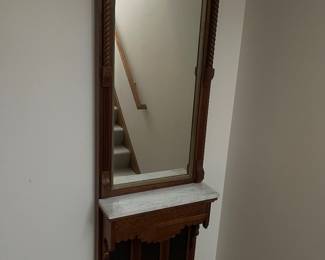 Antique Eastlake-style hall mirror with marble shelf.