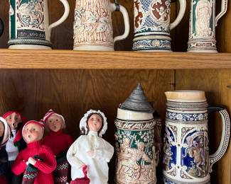 Collections of vintage German beer steins and Byers’s Choice Caroler figurines.