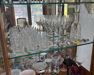 Large selection of Waterford crystal, other fine crystal and glassware, and a fun collection of martini glasses in various styles.