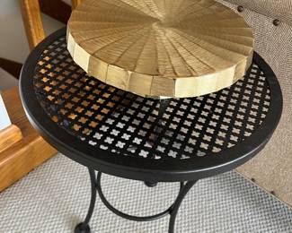 Black metal bistro table; decorative gold cake stand.
