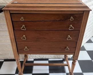Antique four-drawer chest with carved legs.