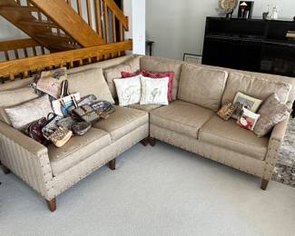 Beige upholstered sectional sofa by Paul Robert, Inc.