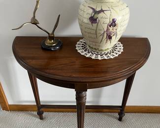 Console table; vintage brass sculpture of seagulls in flight; decorative vase with hummingbird theme.