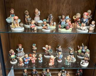 Large collection of Hummel figurines.