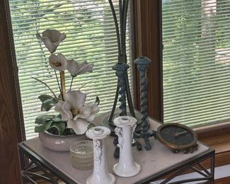 Square side table features a wrought iron base with a light-colored stone top.