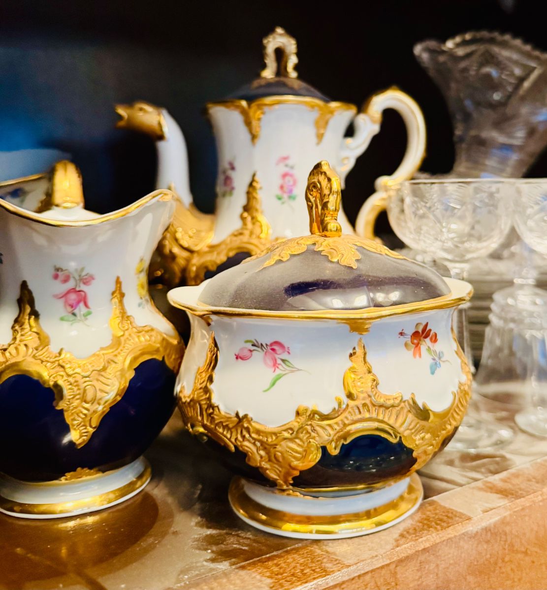 Magnificent Meissen coffee service in “Royal Blue Gold Bronze Strewn Flowers” pattern, Germany, 20th century.  Inspired by the German Baroque and Rococo periods.    The pieces are hand painted on porcelain with opulent 23 karat gold on the high relief of the ornaments and borders. 
