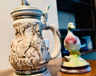 vintage 1991 Avon "Great Dogs of the Outdoors" beer stein featuring an embossed dog scene and a pewter lid