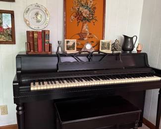Wurlitzer spinet piano, with bench and sheet music.