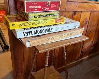 Vintage board games. Anti Monopoly, backgammon, tennis, pit, and others. Vintage wood side table