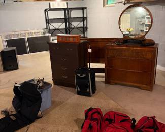 Shelving, waterfall, depression, dresser with mirror,, Dresser, massage seats, and duffel bags.
