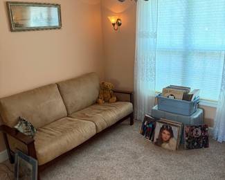 Casual couch, large selection of country, western albums, and nicely framed artwork.