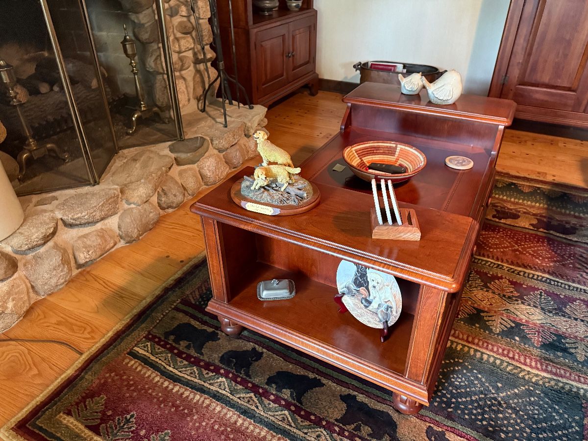 Inlaid mahogany coffee table with end bookcases and turned legs $400