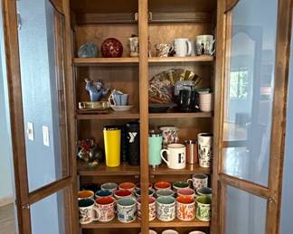 Wooden Curio Cabinet with Assorted Mugs and Decorative Items