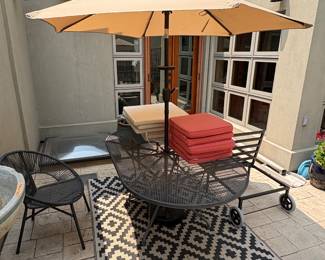 Outdoor oval wrought iron table, umbrella, lounge chairs