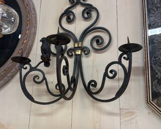 There are a pair of these wrought iron sconces 