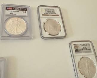 Assortment of Graded Coins: American Silver Eagles and a Winston Churchill Commemorative