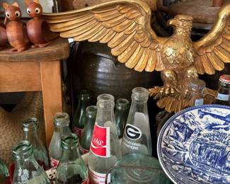 Gilt eagle, Coca-Cola bottles, and blue transferware platter