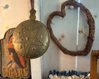Carved wood cigar signs and wicker wreath